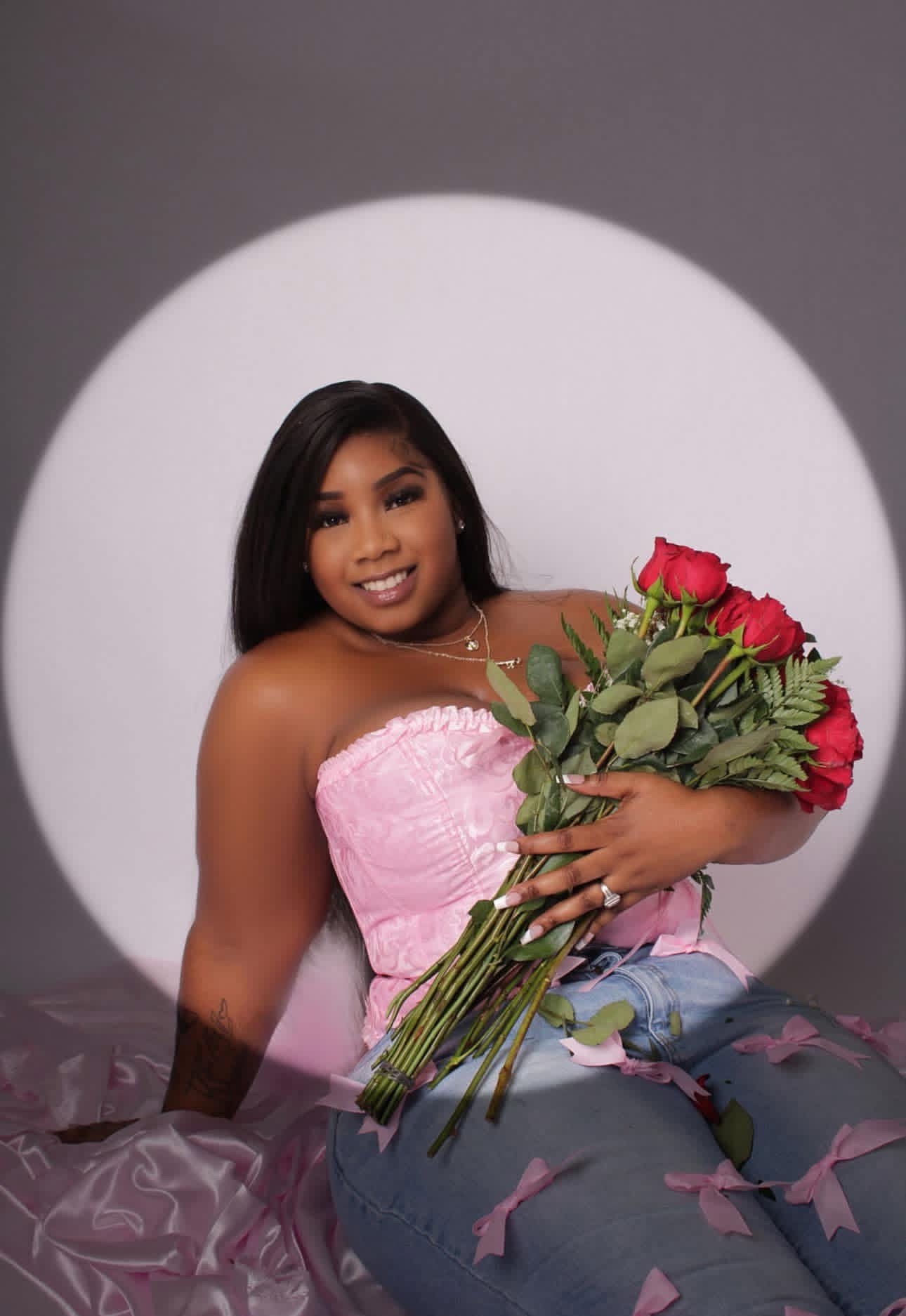 The JP Kollection model holding a bouquet of red roses